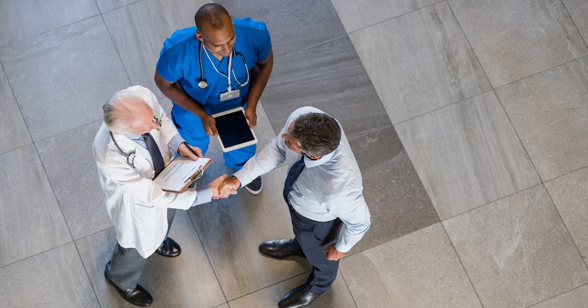 medical professionals and business staff agreeing on operational efficiency initiatives 