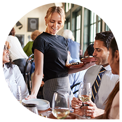 Waitress serving table of patrons